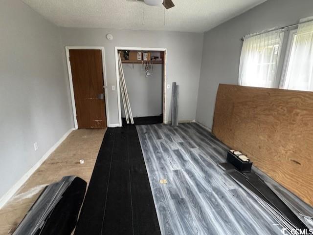 15 Mango Street Andrews, SC 29510 - Photo 15 of 26 Unfurnished bedroom with a textured ceiling, a closet, wood finished floors, and ceiling fan