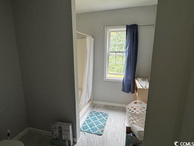 15 Mango Street Andrews, SC 29510 - Photo 10 of 26 Bathroom with shower / bath combination with curtain and light wood finished floors