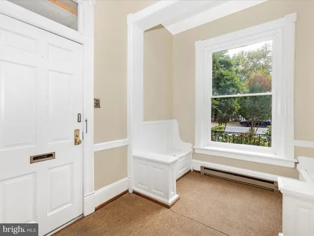 a kitchen with a refrigerator sink and cabinets