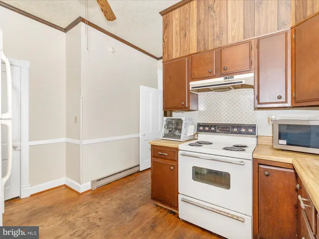 a bathroom with a shower a mirror and a sink