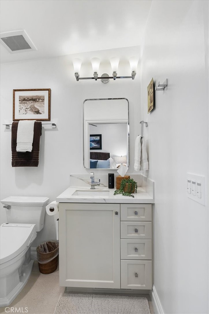 737 Griffith Way Laguna Beach, CA 92651 - Photo 13 of 29 a room with a sink a vanity and mirror
