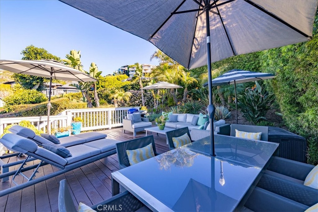 737 Griffith Way Laguna Beach, CA 92651 - Photo 19 of 29 a view of a patio with couches table and chairs under an umbrella