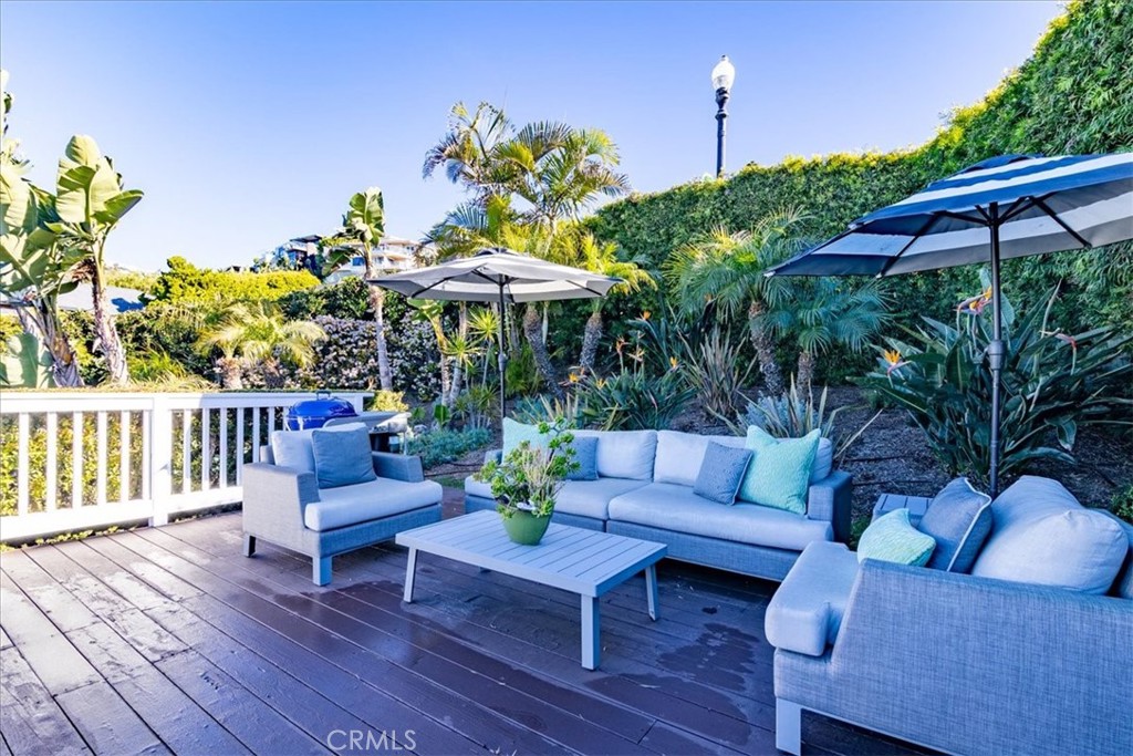 737 Griffith Way Laguna Beach, CA 92651 - Photo 20 of 29 a view of a patio with couches table and chairs under an umbrella