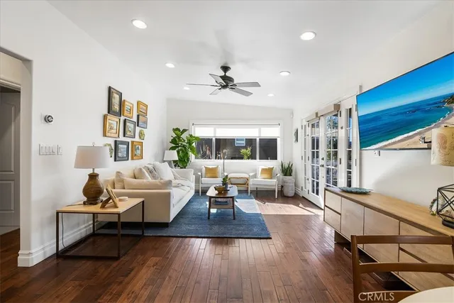 a living room with furniture fireplace and wooden floor