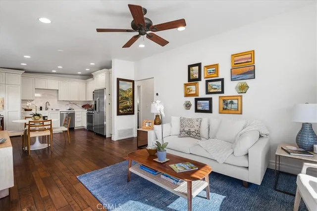 a living room with furniture and kitchen view