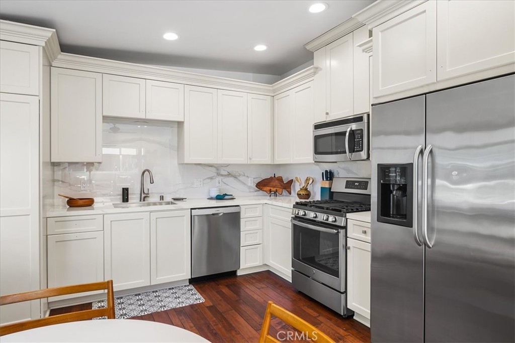 737 Griffith Way Laguna Beach, CA 92651 - Photo 8 of 25 a kitchen with white cabinets and stainless steel appliances