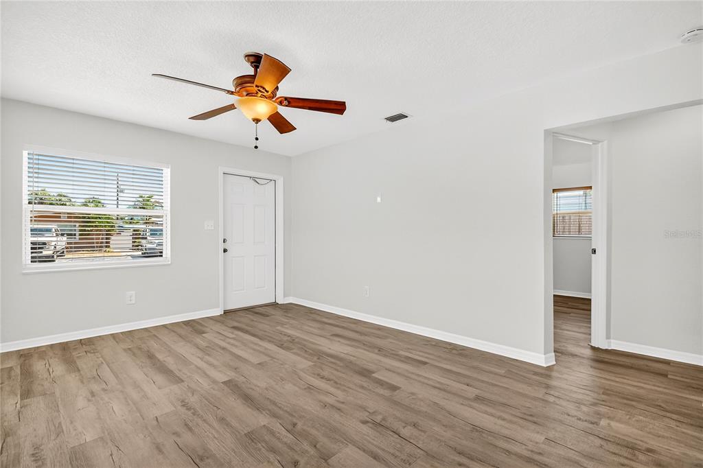 13440 1st Street East Madeira Beach, FL 33708 - Photo 30 of 44 wooden floor in an empty room with a window
