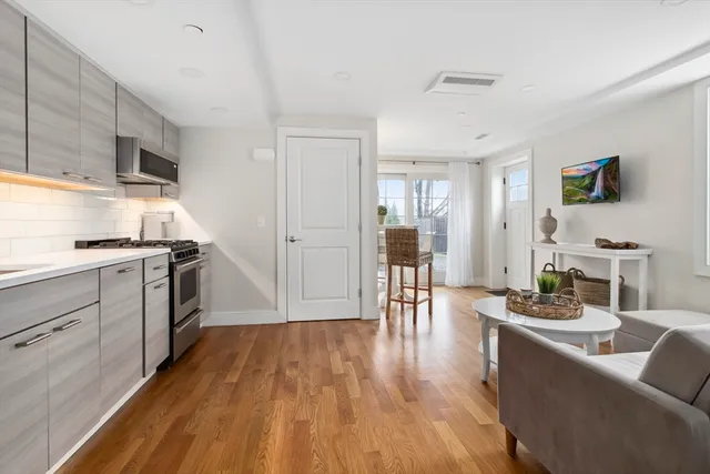 a kitchen with white cabinets and stainless steel appliances