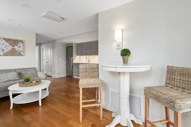 a living room with furniture a potted plant and a fireplace