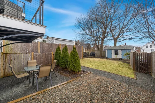 a view of a chairs and table in backyard of the house