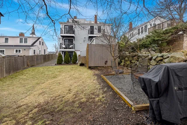 a view of a backyard with furniture and a yard