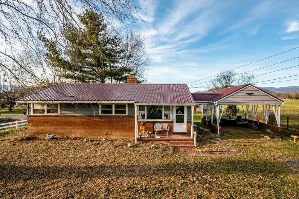 1450 Clover Hill Road Dayton, VA 22821 - Photo 1 of 16 a backyard of a house with barbeque oven table and chairs