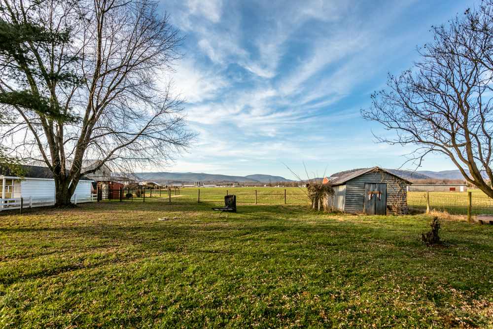 1450 Clover Hill Road Dayton, VA 22821 - Photo 15 of 16 a view of a big house with a big yard and large trees