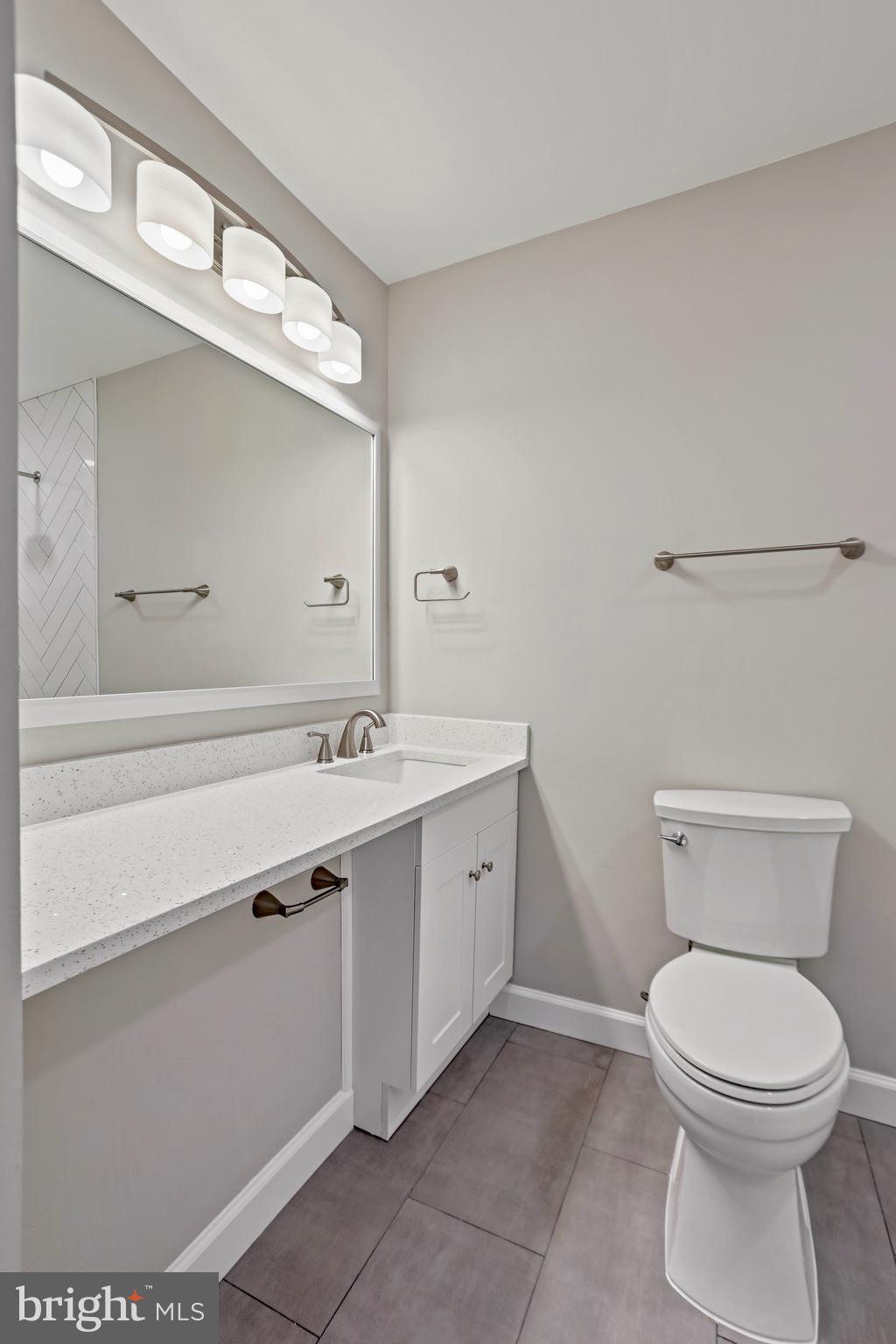 600 East Poplar Road Sterling, VA 20164 - Photo 18 of 32 a bathroom with a sink a toilet and mirror