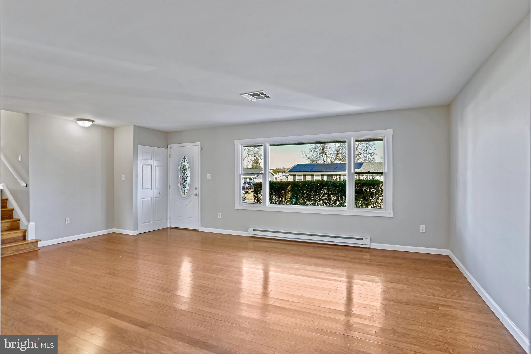 600 East Poplar Road Sterling, VA 20164 - Photo 4 of 32 a view of an empty room with wooden floor and a window