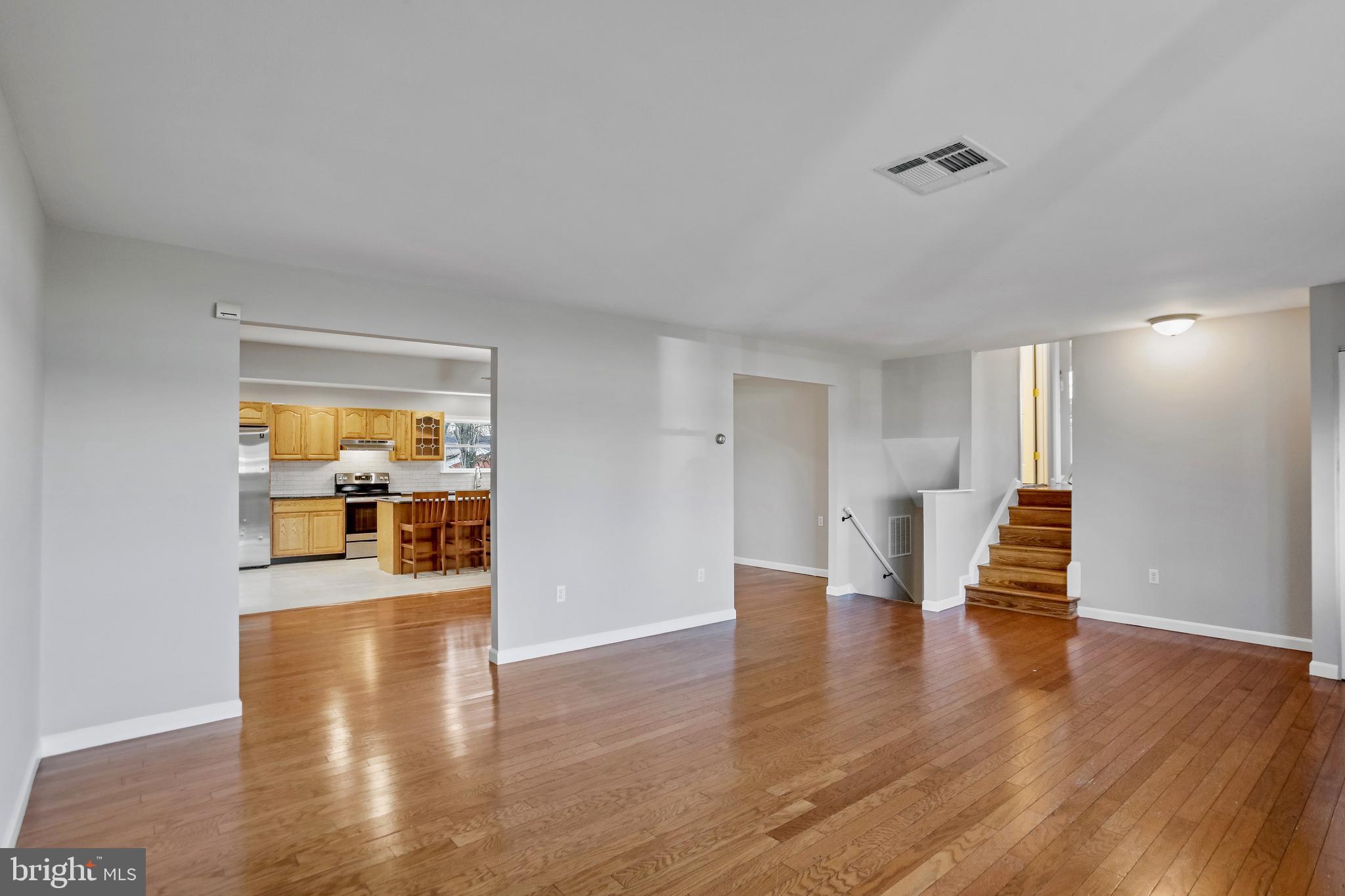 600 East Poplar Road Sterling, VA 20164 - Photo 5 of 32 a view of an empty room with wooden floor and a window