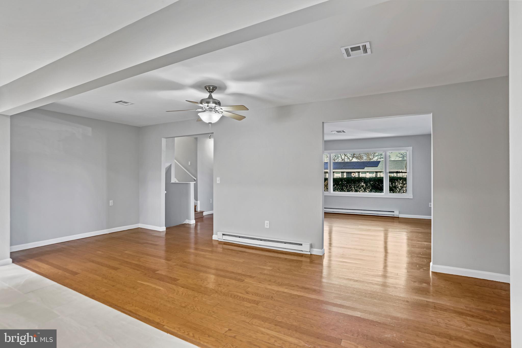 600 East Poplar Road Sterling, VA 20164 - Photo 6 of 32 a view of an empty room with wooden floor and a window