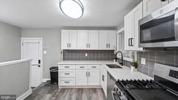 a kitchen with a stove and a microwave