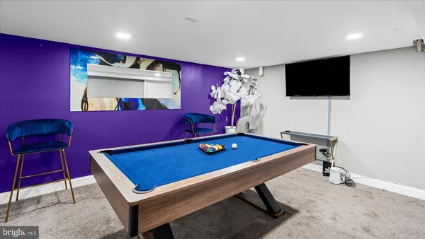 a room with pool table and windows
