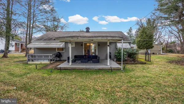 a view of a house with backyard porch and sitting area