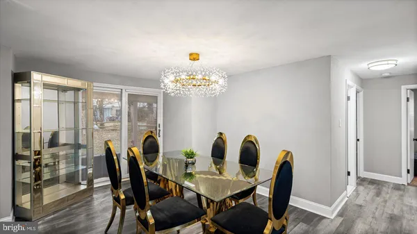 a view of a dining room with furniture and chandelier