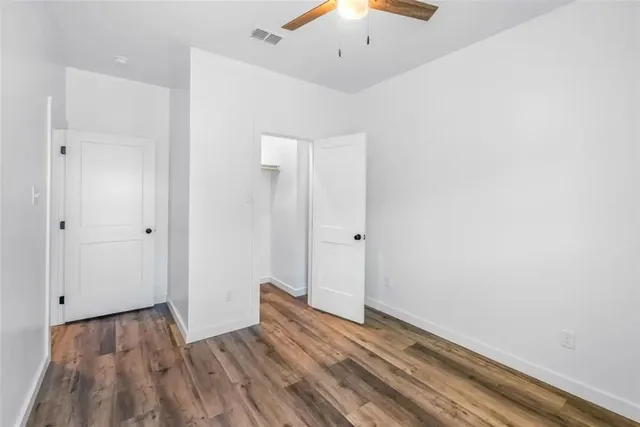 a view of room with wooden floor