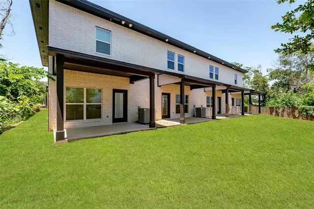 a view of a house with backyard porch and sitting area