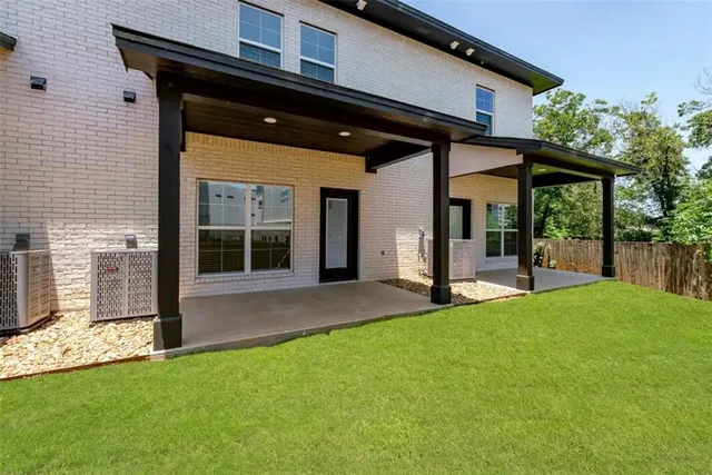 a view of a house with backyard and porch