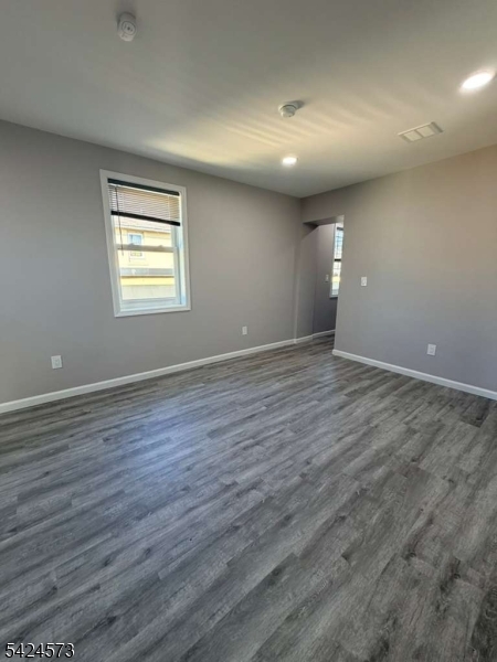 206 Talmage Avenue Bound Brook, NJ 08805 - Photo 12 of 18 an empty room with wooden floor and windows