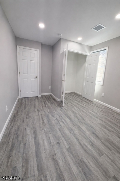 206 Talmage Avenue Bound Brook, NJ 08805 - Photo 13 of 18 an empty room with wooden floor and windows