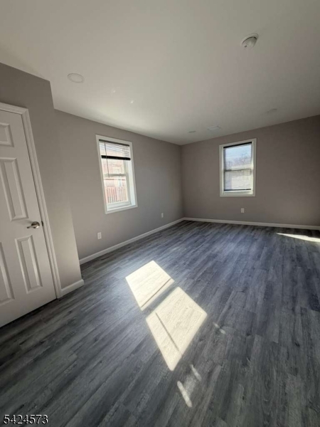 206 Talmage Avenue Bound Brook, NJ 08805 - Photo 15 of 18 an empty room with wooden floor and windows