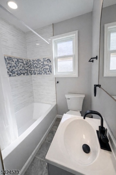 206 Talmage Avenue Bound Brook, NJ 08805 - Photo 16 of 18 a bathroom with a sink a bathtub and a shower
