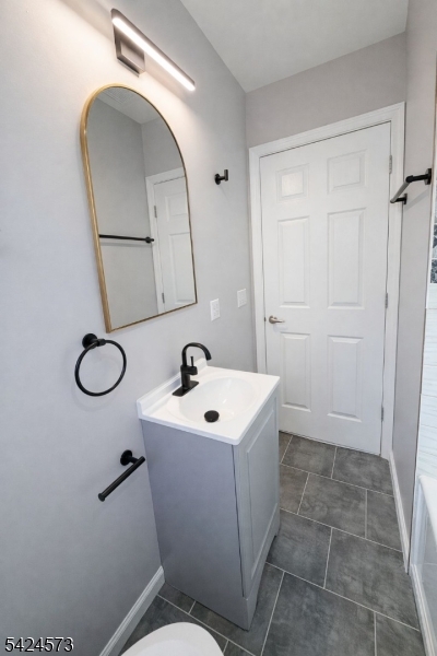 206 Talmage Avenue Bound Brook, NJ 08805 - Photo 17 of 18 a bathroom with a toilet sink and mirror