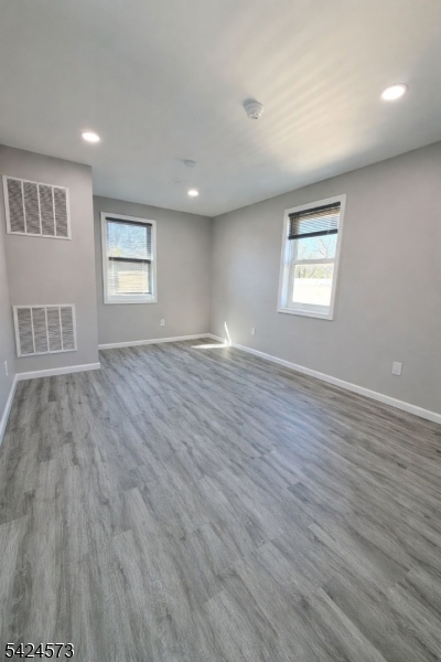 206 Talmage Avenue Bound Brook, NJ 08805 - Photo 4 of 18 a view of an empty room with wooden floor and a window