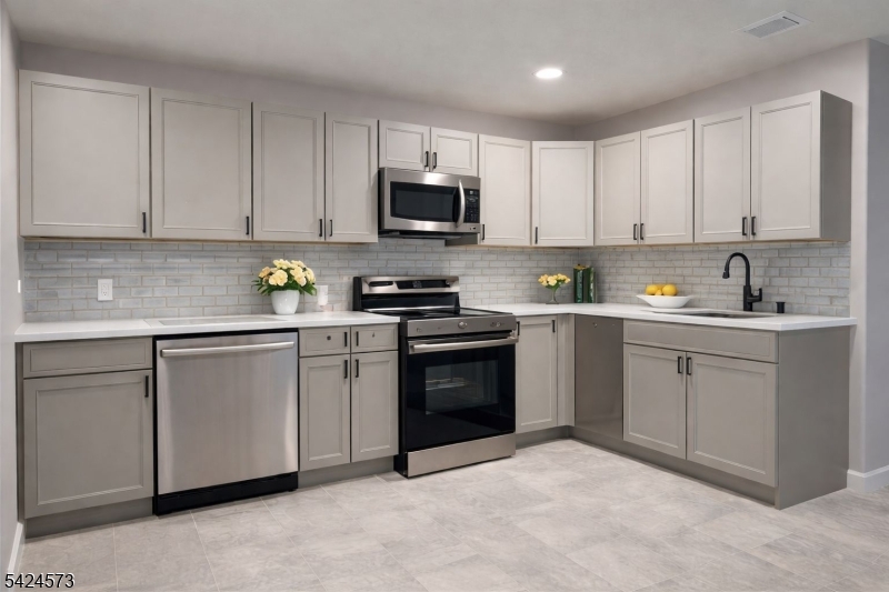 206 Talmage Avenue Bound Brook, NJ 08805 - Photo 5 of 18 a kitchen with white cabinets sink and stainless steel appliances