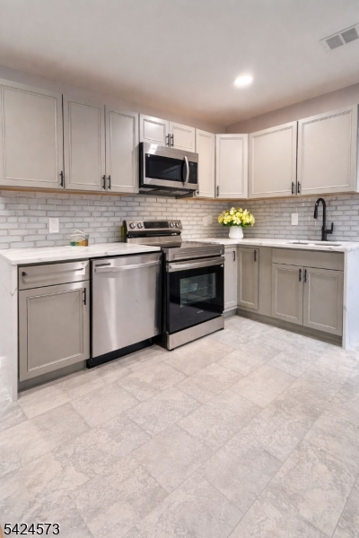 206 Talmage Avenue Bound Brook, NJ 08805 - Photo 6 of 18 a kitchen with stainless steel appliances granite countertop a stove top oven a sink dishwasher and a refrigerator