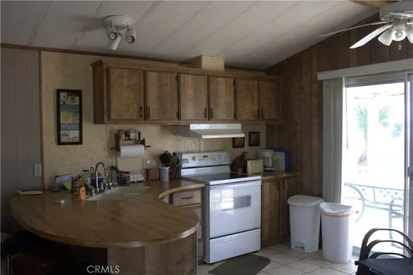a kitchen with kitchen island a stove a sink and a refrigerator
