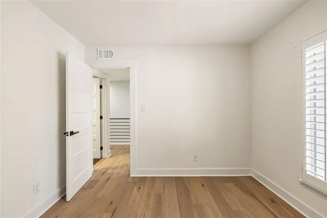 a bathroom with a granite countertop sink toilet a mirror a vanity and shower