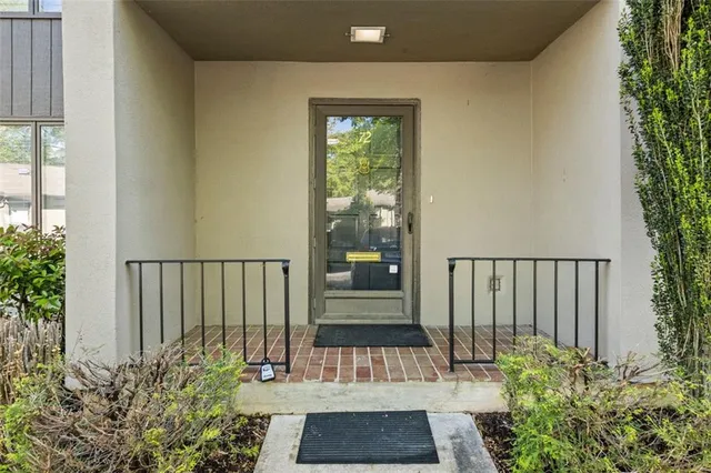 a kitchen with stainless steel appliances granite countertop a sink dishwasher a stove and white cabinets with wooden floor