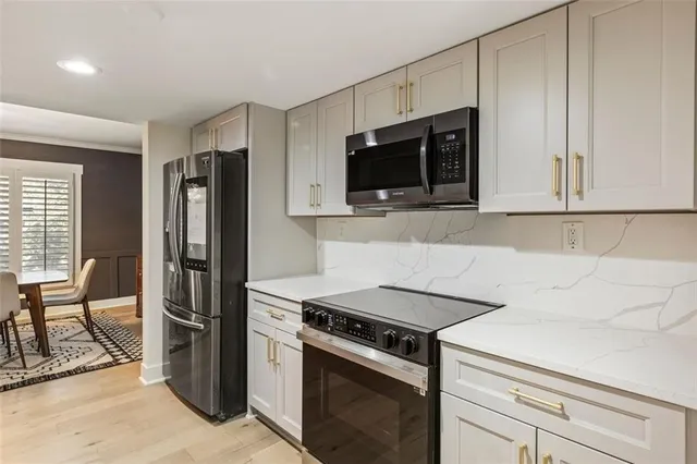 a view of a dining room with furniture a chandelier and wooden floor