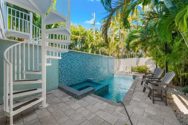 a kitchen with stainless steel appliances granite countertop a refrigerator a stove a sink and a microwave