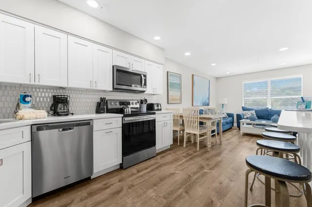 a view of dining room with furniture and wooden floor