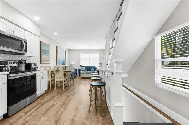 a bedroom with a bed and a flat tv screen on dresser