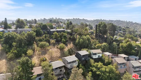 an aerial view of a house with mountain view
