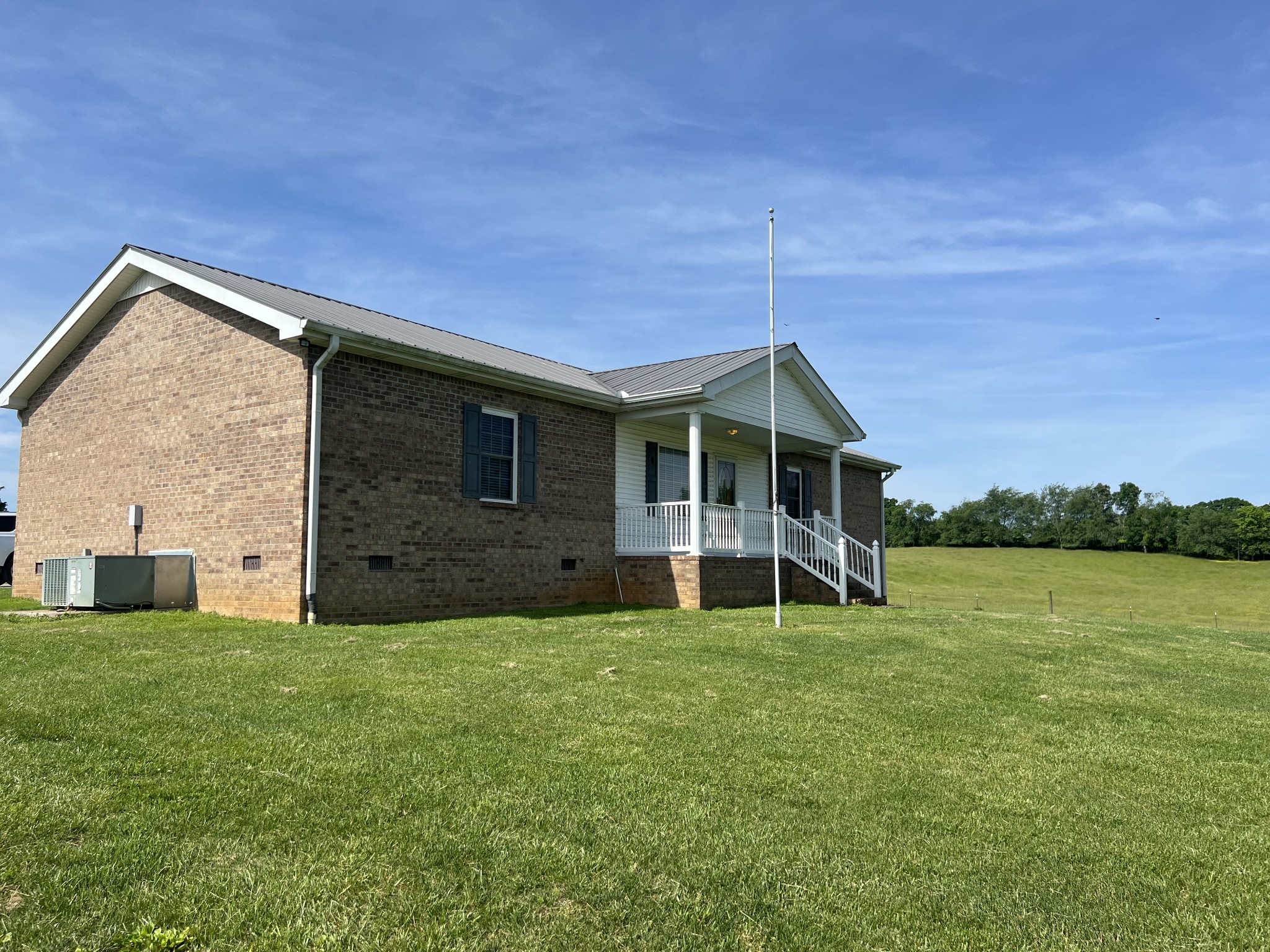 a view of a house with a yard and sitting area