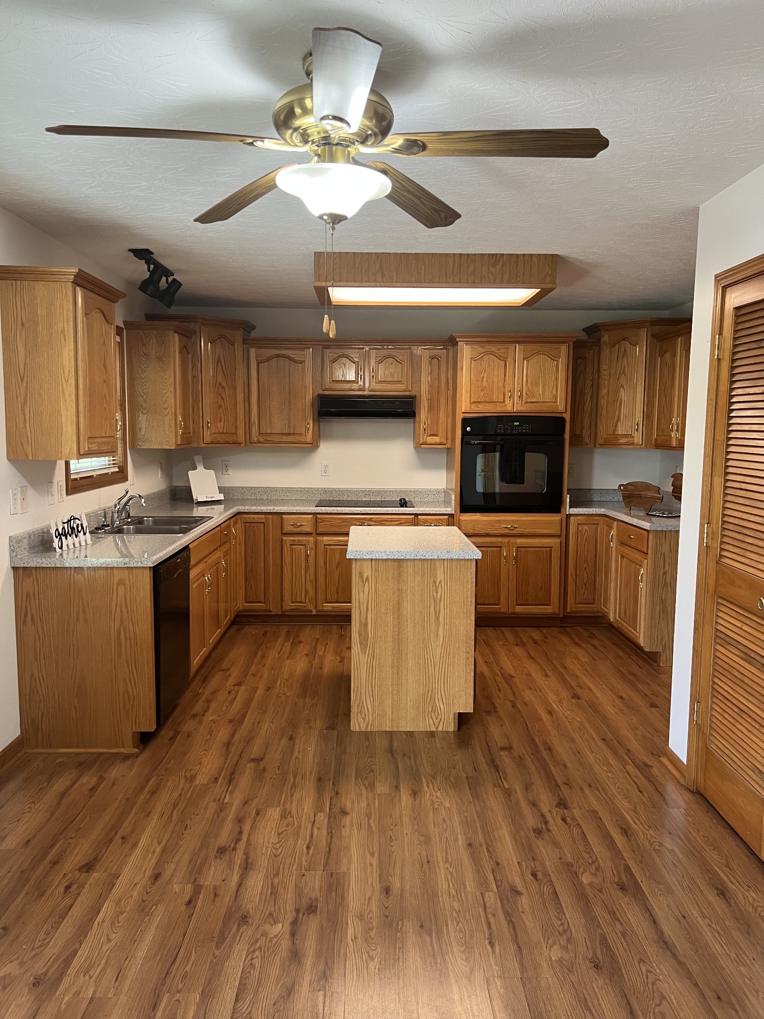 152 Bosham Road Westmoreland, TN 37186 - Photo 18 of 53 an open kitchen with wooden floor and stainless steel appliances