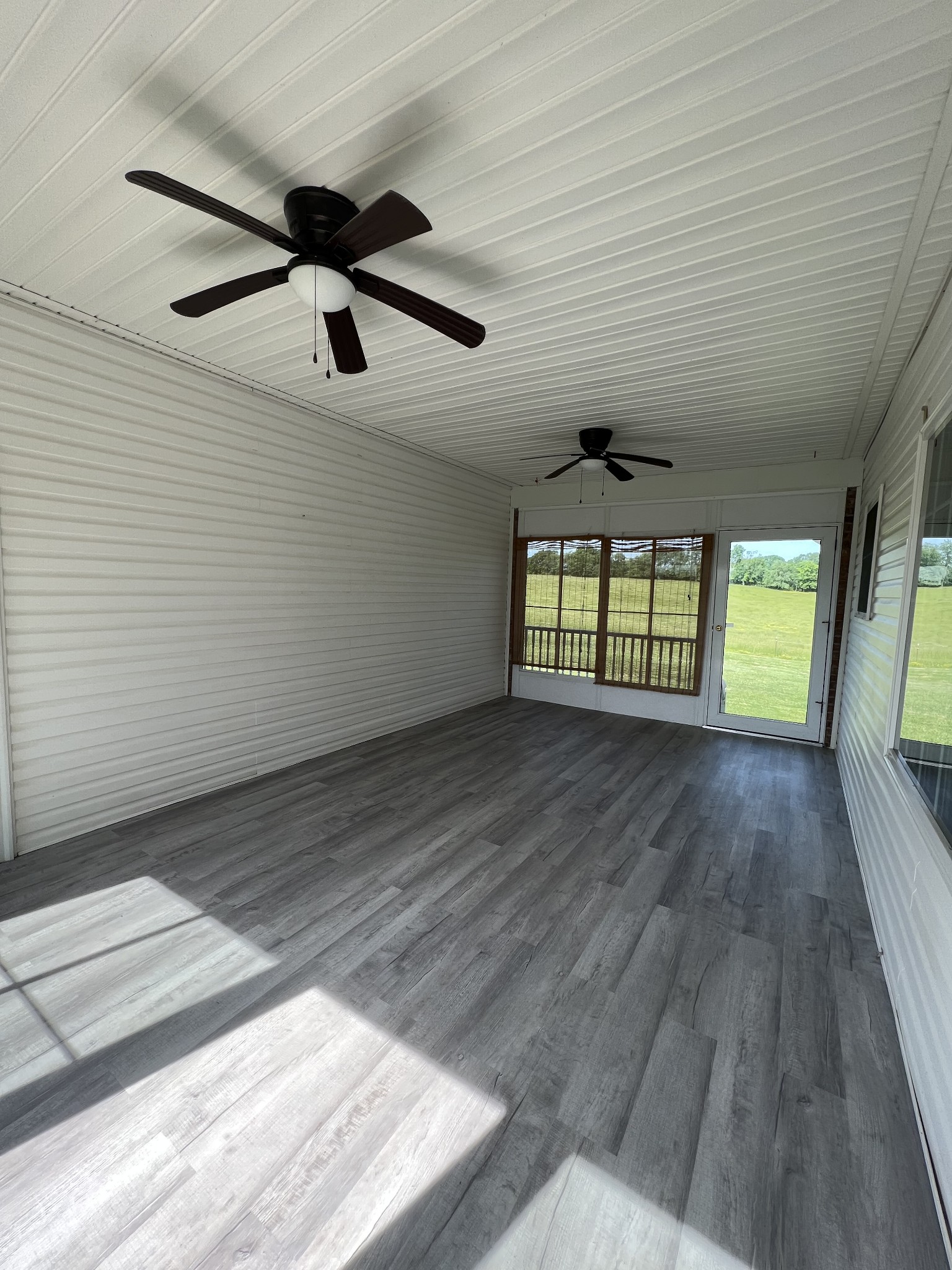 152 Bosham Road Westmoreland, TN 37186 - Photo 27 of 53 en empty room with wooden floor and windows