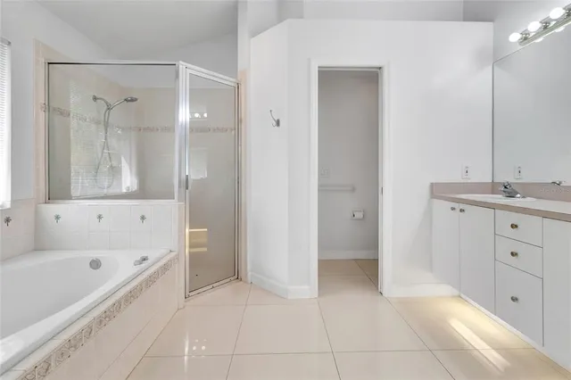 a bathroom with a bathtub shower and a sink