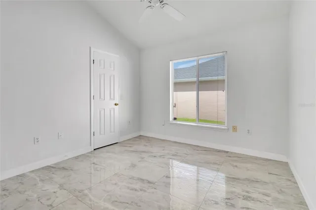 an empty room with windows and closet