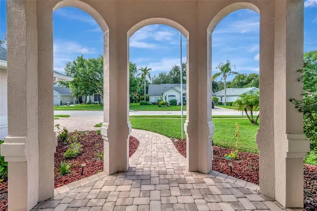 a view of a porch with a potted plant and floor to ceiling window